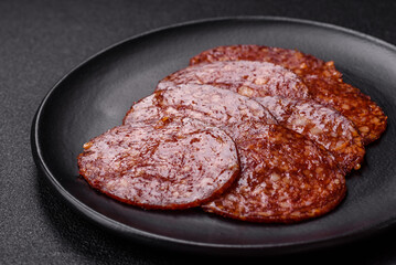 Delicious smoked pepperoni sausage sliced with salt, spices and herbs