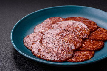 Delicious smoked pepperoni sausage sliced with salt, spices and herbs