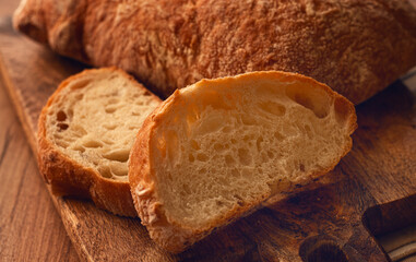 sliced ciabatta , on a chopping board, italian bread, close-up, Italian cuisine, breakfast, no people,