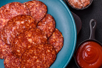 Delicious smoked pepperoni sausage sliced with salt, spices and herbs
