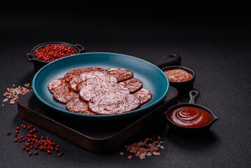 Delicious smoked pepperoni sausage sliced with salt, spices and herbs