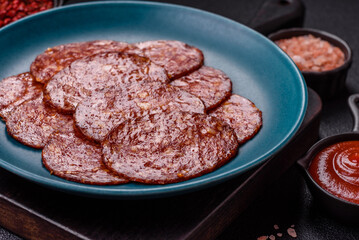 Delicious smoked pepperoni sausage sliced with salt, spices and herbs