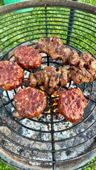 merguez meatballs and meat skewers on the charcoal grill