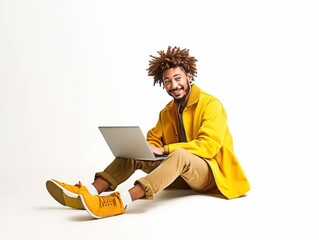 Man sitting on the floor using a laptop in a bright space