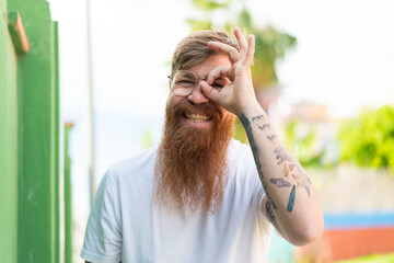 Redhead man with beard With glasses with happy expression