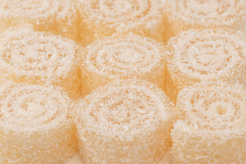 Coconut candy roll isolated on a white background.