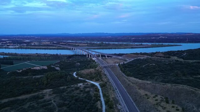 Panoramic aerial view of the double viaduct for high-speed passenger trains over the Rh&ocirc;ne river in Avignon during sunset - France