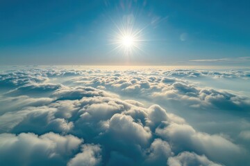 Fototapeta premium Aerial view of the sun shining in a blue sky with a blanket of clouds below, creating a heavenly feel