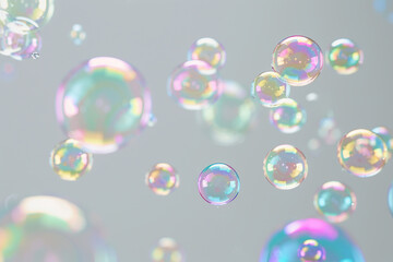 Naklejka premium Rainbow soap bubbles on grey background