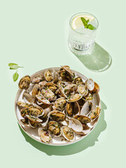 Vongole with basil and onion on a white plate