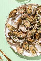 Vongole with basil and onion on a white plate