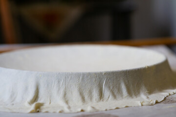 Pan covered with a rolled dough. Traditional way of making balkan pie