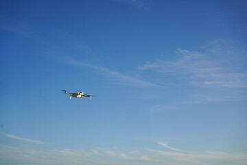 Modern UAV drone quadcopter with camera ready to start. Blue sky. High quality photo