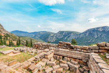 Delphi with ruins of the Temple of the ancient Sanctuary of Apollo in Delphi, Greece, at the Mount Parnassus