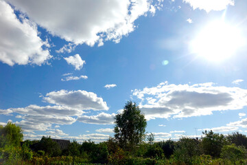 Blue Sky With Fluffy White Clouds Over a Vibrant Countryside Landscape During the Day