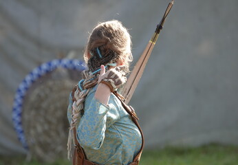 An elegant archer after shooting an arrow from a bow. Medieval woman archer. Archery. An elven...