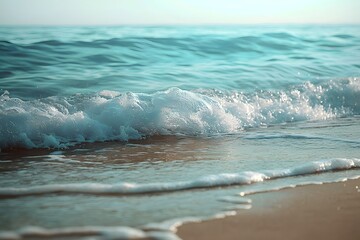 A serene beach scene showcasing gentle waves and soft sand.