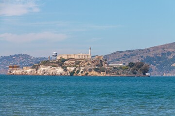 Alcatraz Island historic prison and lighthouse, surrounded by the blue waters of San Francisco Bay.