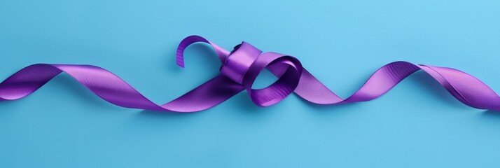 Fototapeta premium A purple ribbon tied in a bow, symbolizing elegance, celebration, gift wrapping, femininity, and love.
