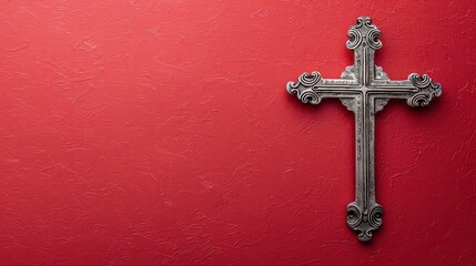 A silver cross on a brown textured background with copy space.