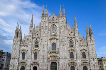 Fototapeta premium Milan, Italy. AUG 3,2024. Famous Cathedral Duomo di Milano with Gothic spires and marble statues.
