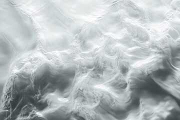 Fototapeta premium Gentle white water waves create subtle ripples on a light surface, showcasing the serene beauty of moving water from above during daylight