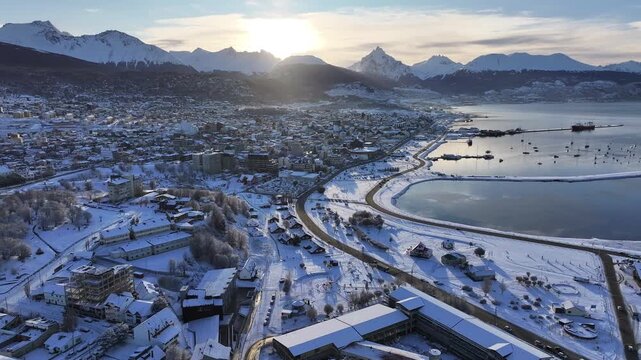 Ushuaia Skyline At Ushuaia Tierra Del Fuego Argentina. Aerial View Of A High-Rise Buildings And Traffic Showcasing Urban Life. Sunset Snowflakes Tourism Iceland Blizzard.