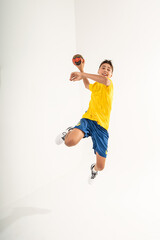 One happy handball player, teenager boy in studio isolated on white background. Hobby and healthy lifestyle