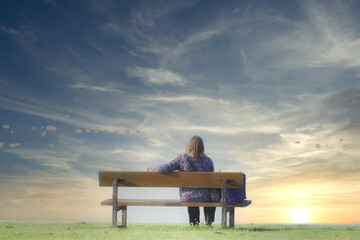 Single lady lonely on park bench at the sea enjoy peace and quiet for mindfulness meditation