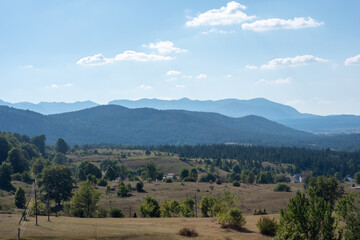 landscape of green field in the mountains on a sunny day