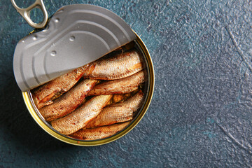Canned smoked sprats on dark background