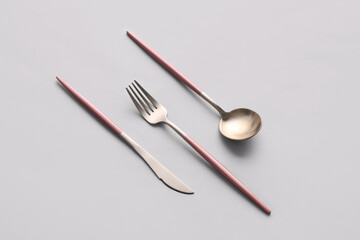 Stylish cutlery on grey background