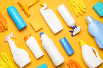 Different cleaning supplies on orange background