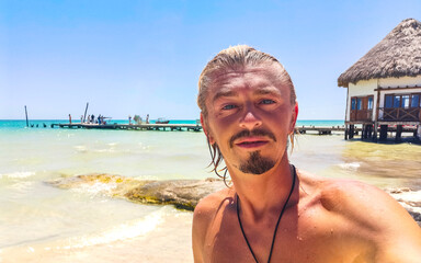 Beautiful Holbox island beach sandbank panorama handsome sexy male tourist Mexico.