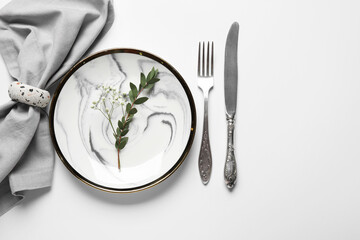 Beautiful table setting and gypsophila flowers on white background