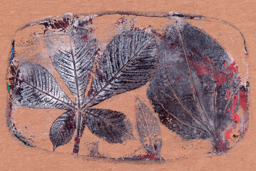 Naklejka premium imprints of real leaves on paper, creative abstract grunge background