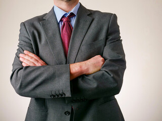 A man in a suit and tie with his arms crossed. Concept of professionalism and authority. Portrait...