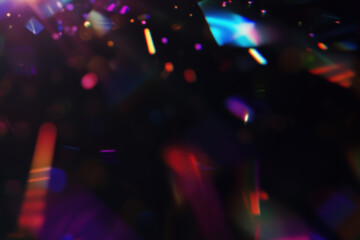 Iridescent prism light effect on black background, rainbow of colors on the black background. Glowing colorful lights and a bokeh lens flare with space, abstract refraction of sunlight prism effect