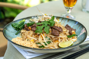 Pad thai, phat thai, or phad tha asian noodles, chinese rice pasta with meat in thailand...