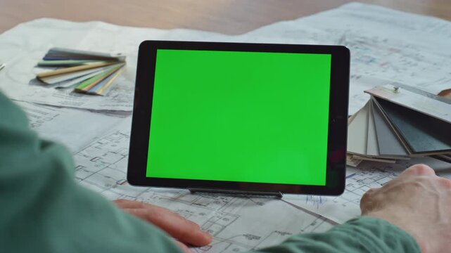 Construction specialist watching greenscreen tablet at creative agency closeup. 
