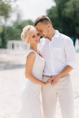 Romantic Couple Embracing on a Sandy Beach in Summer