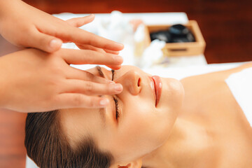 Closeup woman enjoying relaxing anti-stress head massage and pampering facial beauty skin...