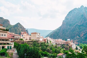A mountain range with a small town in the valley