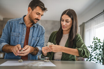 Couple learn and practice how to make a clay figurine, pottery