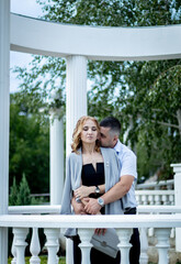 Portrait of a beautiful young caucasian couple in the gazebo.