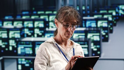 Skilled computer scientist in data center equipped to handle complex computing requirements, doing...