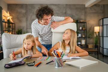 Single father help to his daughters to do homework