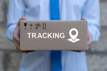 Business man or delivery man holding delivering parcel with text on cardboard box: TRACKING....