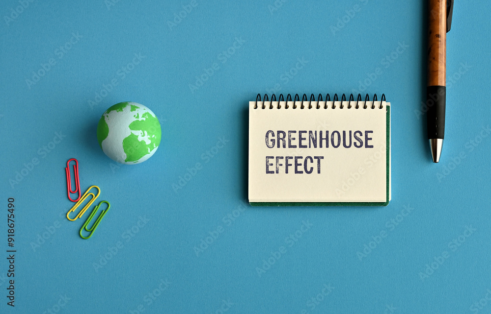 Poster there is notebook with the word greenhouse effect. it is as an eye-catching image.