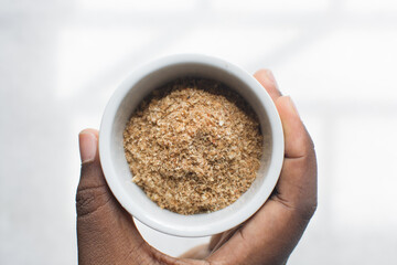 Overhead view of ground dried crayfish, top view of dried shrimp powder, flatlay of nigerian crayfish powder on a white background